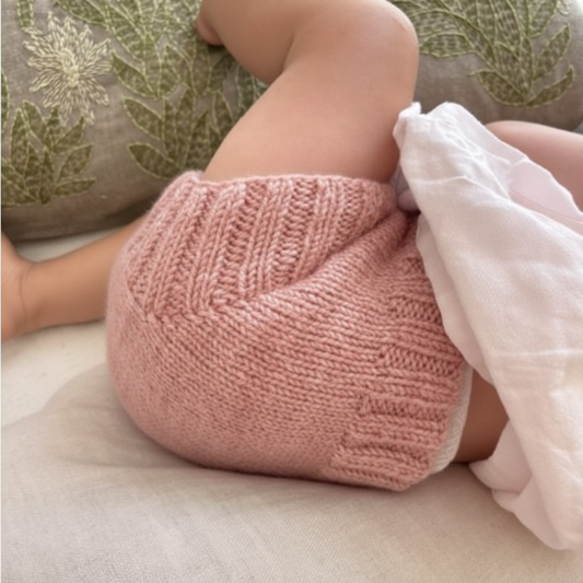 Baby wearing rose pink merino wool nappy soaker